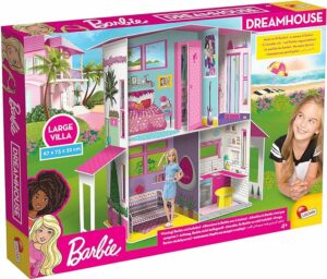 Fille jouant avec la Maison de Rêve Barbie à construire et décorer avec meubles et autocollants.
